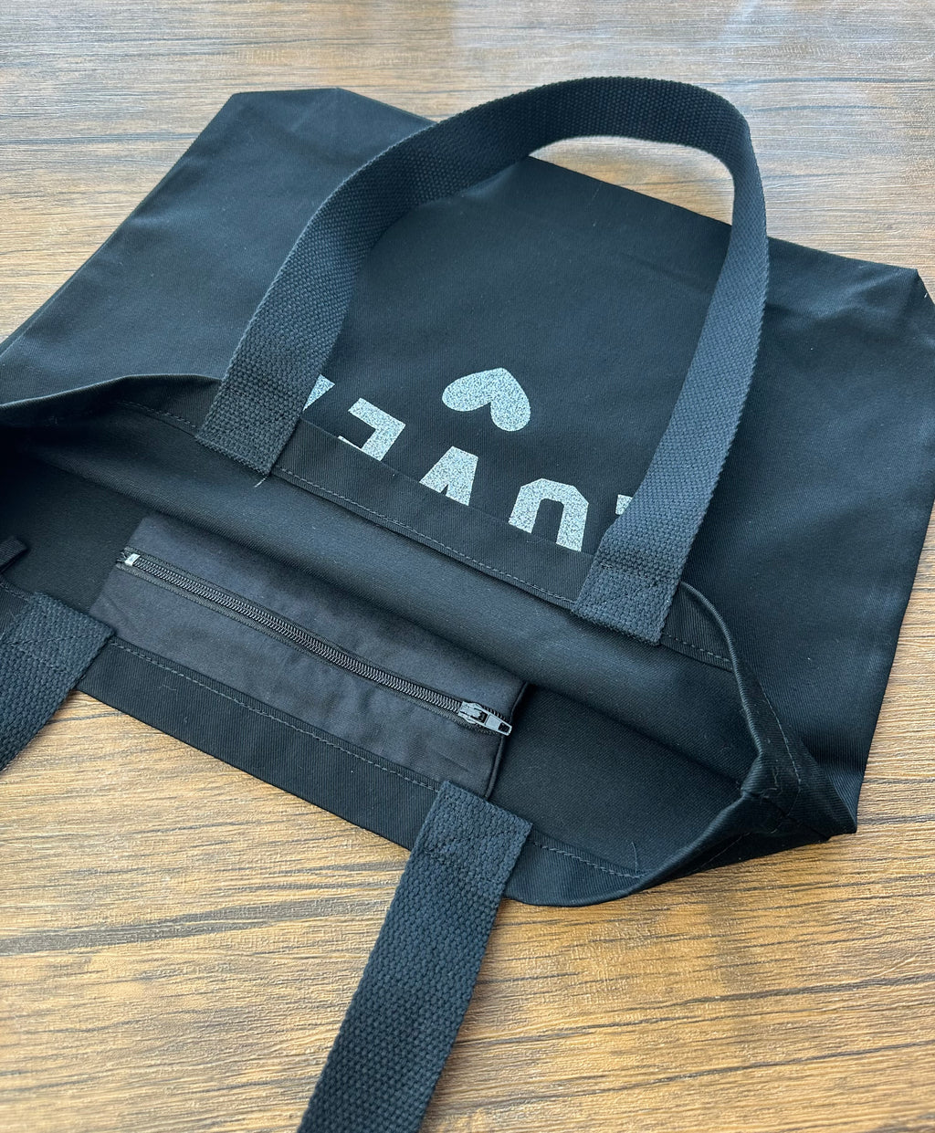 Black tote bag with an inside zip pocket 