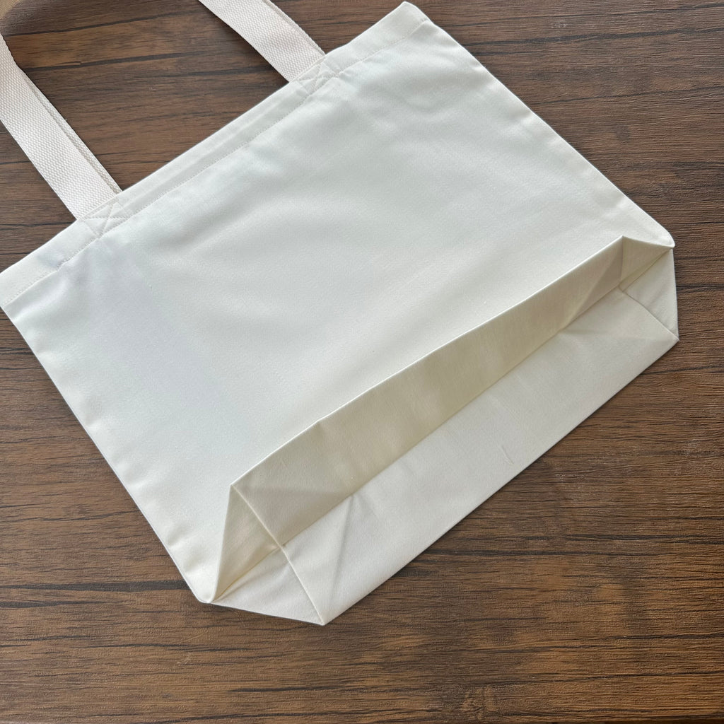 White tote bag on a wooden surface