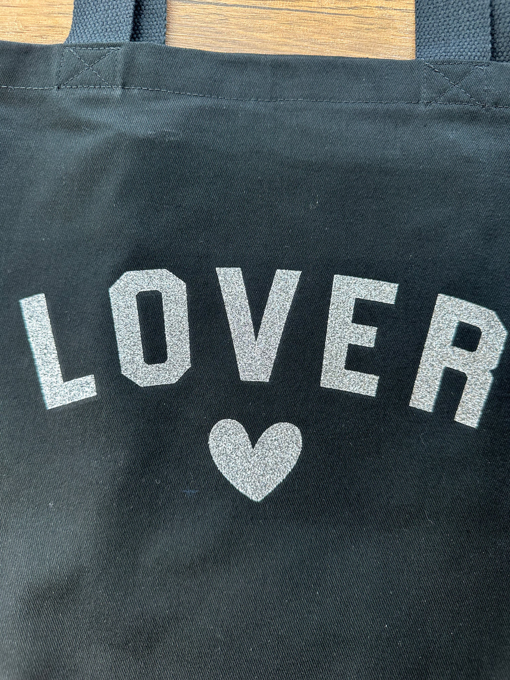 Black bag with 'LOVER' text and heart symbol with glitter vinyl print material