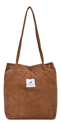 Brown tote bag with a visible brand label on a white background