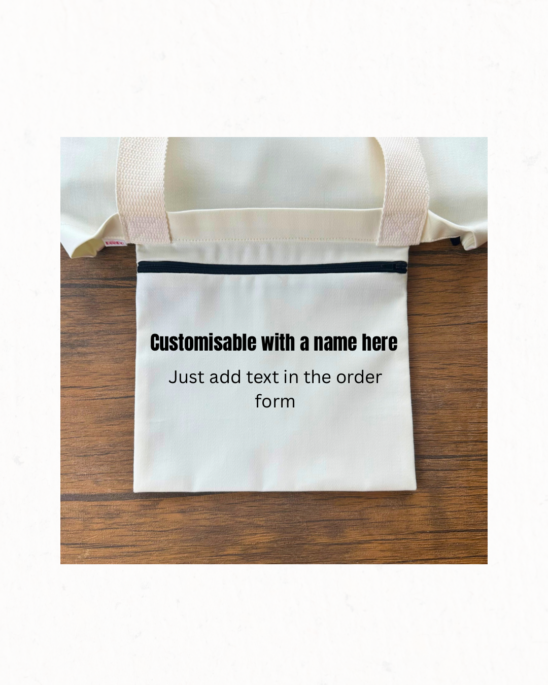 White tote bag with customizable text on a wooden surface