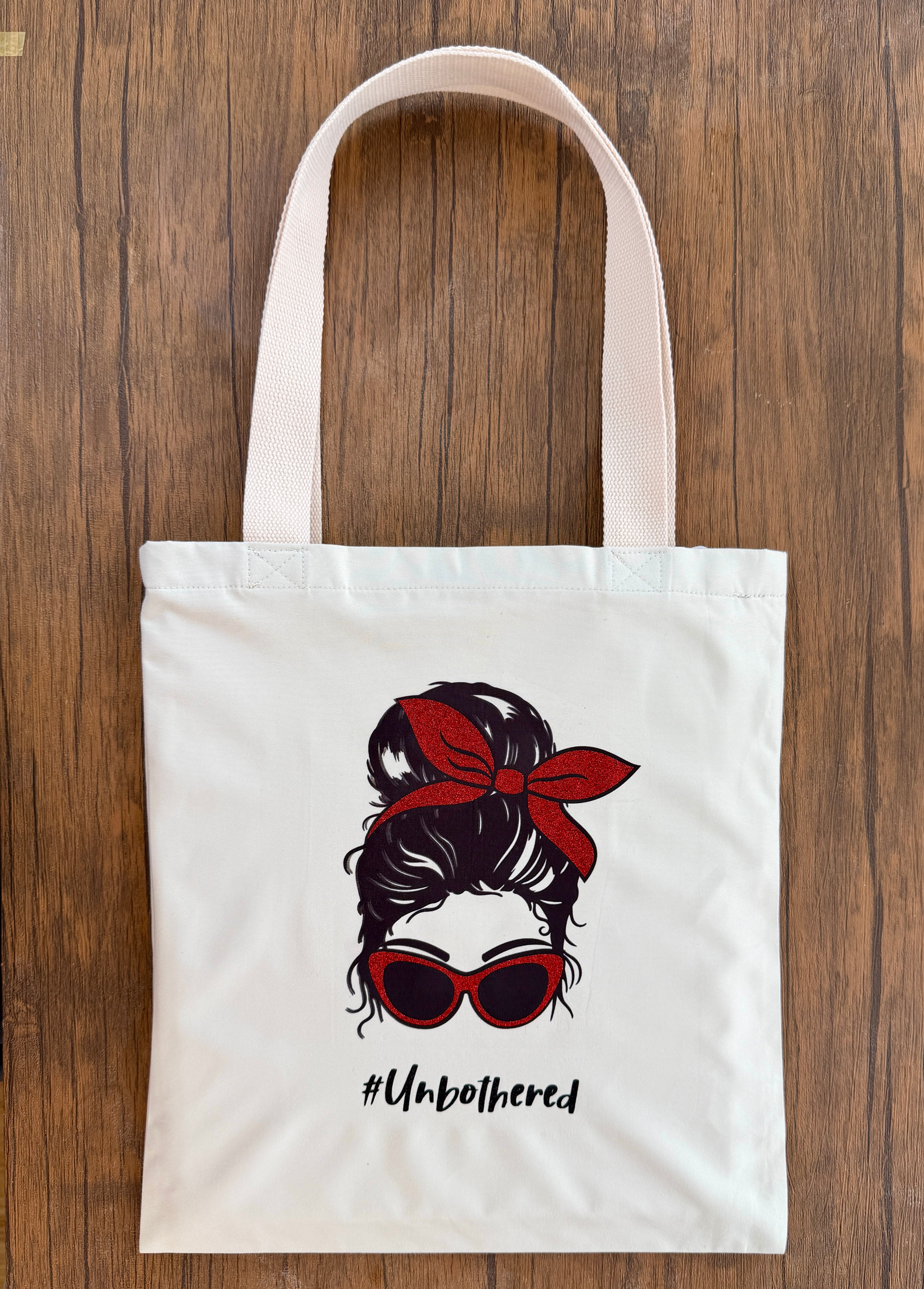tote bag with female print with red ribbon and red sunglasses glitter print and unbothered text