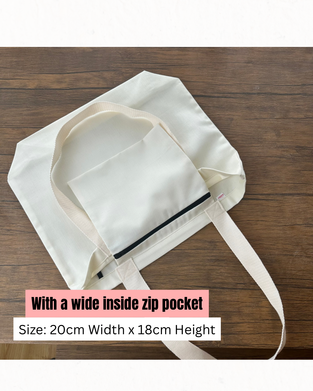 White bag with a wide inside zip pocket on a wooden surface