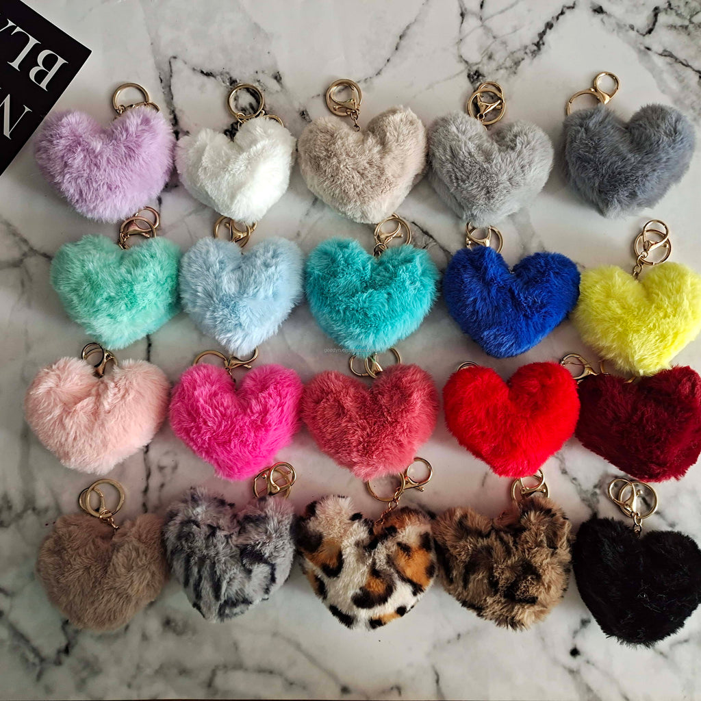Colorful heart-shaped keychains on a marble surface