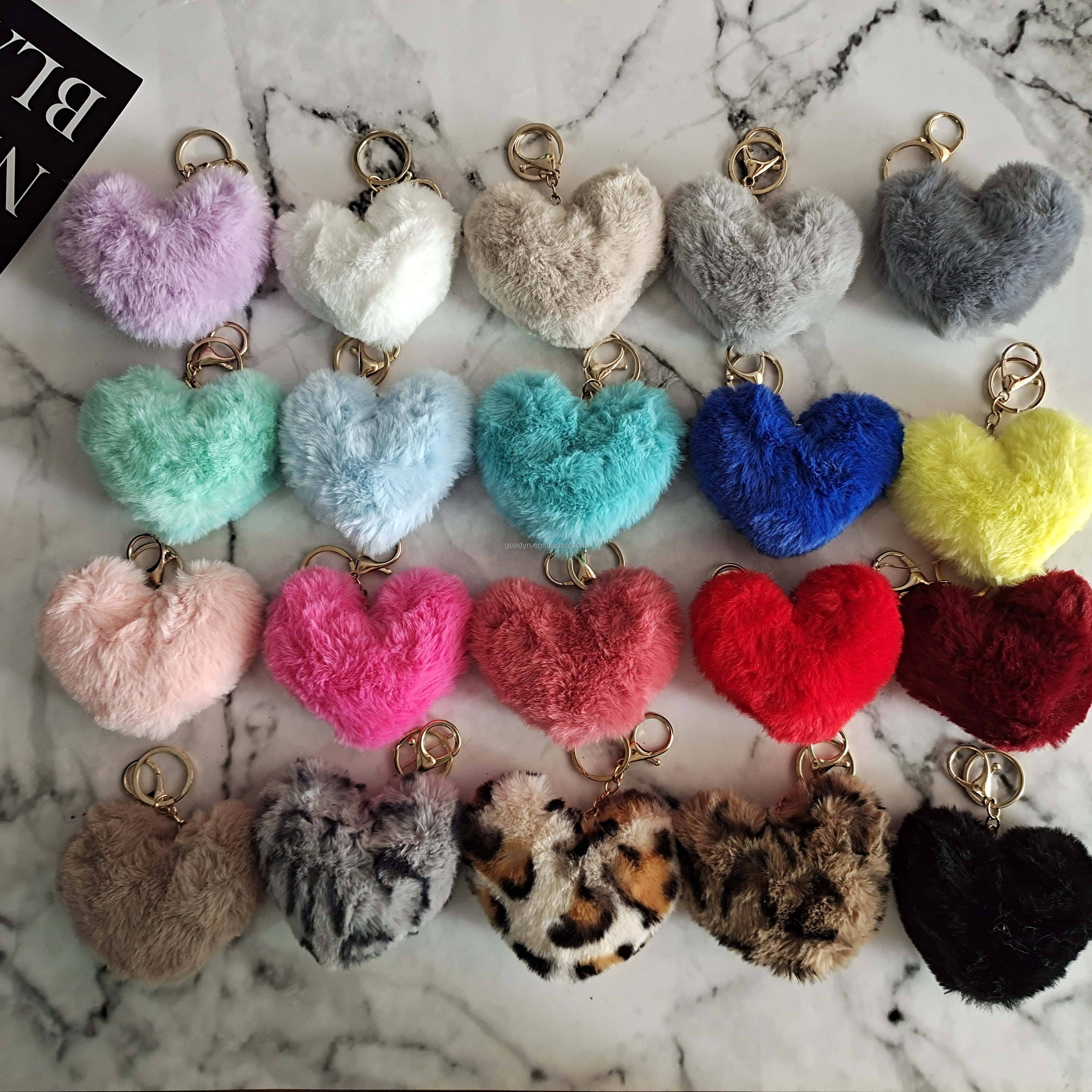 Colorful heart-shaped keychains on a marble surface