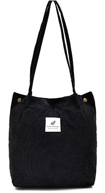 Black tote bag with a visible brand label on a white background