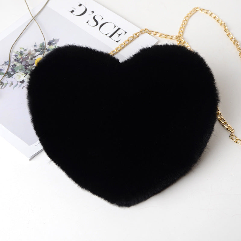 Black heart-shaped bag with a gold chain on a white background gifts for her UK