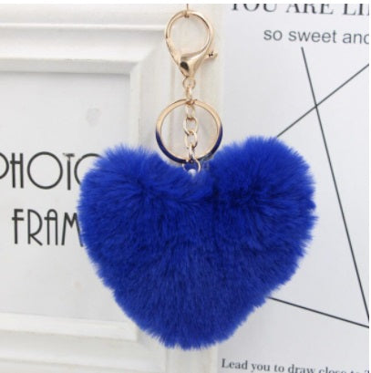 Blue heart-shaped fluffy keychain on a white background