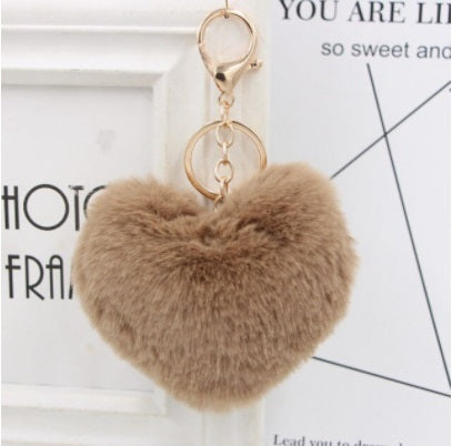 brown Heart-shaped fur keychain on a white background with text overlay