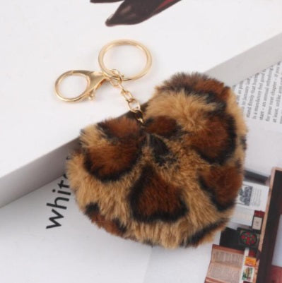 Leopard print fluffy keychain on a newspaper background